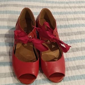 Red peep-toe ribbon-tie shoes from Modcloth.